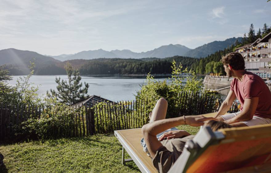 Mann und Frau sitzen am Eibsee im Seegarten